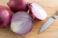 Large red onions on cutting board with knife Royalty Free Stock Photo