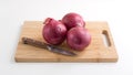 Large red onions on cutting board with knife Royalty Free Stock Photo