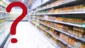 Large red question mark on abstract blur image of supermarket background. Defocused shelves with food and product. Grocery