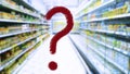 Large red question mark on abstract blur image of supermarket background. Defocused shelves with good and products. Grocery