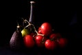 Large red and ripe tomatoes with lime avocado and bottle of beer on black background Royalty Free Stock Photo