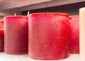 Large red scented candles on display shelf in a store setting Royalty Free Stock Photo