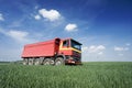 Large red truck in field