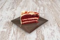 Large red velvet cake with three layers of red sponge cake and three more of white garnish