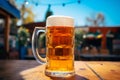 A large refreshing pint of beer or ale on a wooden bench on a summer day Royalty Free Stock Photo
