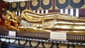 Shiny golden reclining Bhuddha statue