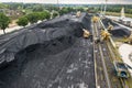 Large reserves coal at a power plant many cranes unloading coal, a lot of coal, top view Royalty Free Stock Photo
