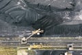 Large reserves of coal at power plant many cranes unloading coal, a lot of coal, top view Royalty Free Stock Photo
