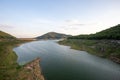 A large reservoir surrounded by mountains. fertile forest Beautiful nature, clear skies, dams with reduced water content. tell