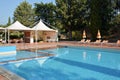 Large resort pool with beach umbrellas, sun loungers and lounge chairs