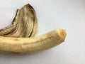 Large ripe peeled banana on a white background. Abstract minimalistic macro shot.