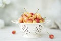 large ripe pink cherries in a white colander Royalty Free Stock Photo