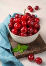 Large ripe red cherries in a beige bowl on a pink background. Summer fruits. Royalty Free Stock Photo