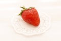The large ripe strawberry on a plate