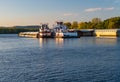 Large river barge on Upper Mississippi being pushed by pair of tugs Royalty Free Stock Photo