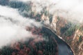 Large river in the canyon among the autumn forest and fog, top v Royalty Free Stock Photo