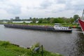 Large riverboat barge tranporting goods along the wide canals of Amsterdam Royalty Free Stock Photo