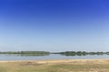 Large riverside sandy beach has a green mangrove forest Royalty Free Stock Photo