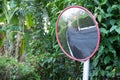 Large road mirror in a rainforest