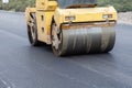 Large road-roller paving a road. Road construction