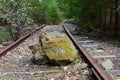 Large rock blocking railroad tracks from a land slide