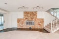 Large rock fireplace in living room family room with carpet staircase and white carpet brown tile floor