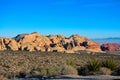 Large rock formations interrupt massive expanse of desert