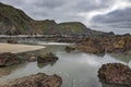 Large rock pool and stormy skies at Duckpool Cornwall Royalty Free Stock Photo
