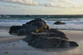 Large Rock in the Sand and Waves Rolling Ashore Royalty Free Stock Photo