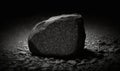 a large rock sitting on top of a gravel field next to a light bulb on a wall of windowsills in a dark room Royalty Free Stock Photo