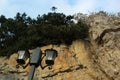 Green trees, nature of the Crimea,a large rock and a street lamp, a quay and a stone coast, rocks on the seashore, a tall black p Royalty Free Stock Photo