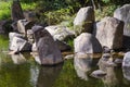 large rocks at a pond of a landscaped Japanese garden Royalty Free Stock Photo