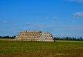 a large roll of baled straw is stacked in a pyramid. warn friends not to Royalty Free Stock Photo