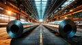 Large rolls of galvanized steel in a spacious industrial warehouse setting Royalty Free Stock Photo
