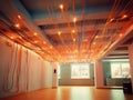 Large room with an open ceiling, where many orange and yellow wires are hanging down. These cables create unique visual