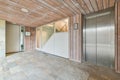 a large room with wooden ceilings and stainless steel doors