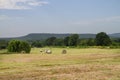 Hay field in eastern Oklahoma with mountains in the distance