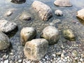 Large round beautiful natural stones cobblestones in water, sea, lake, river. Background, texture Royalty Free Stock Photo