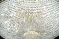 Large round chandelier with crystals and candlesticks on the ceiling, dark background, retro style. Beautiful chandelier in luxury Royalty Free Stock Photo