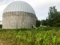 A large round concrete and metal barn for storing grain and corn Royalty Free Stock Photo