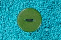 Big green button with thread on a blue background Royalty Free Stock Photo