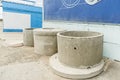 Large round grey precast concrete well ring