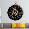 A large round indoor clock on the wall. Big clock on metal rack Royalty Free Stock Photo