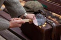 Large round magnifier on long handle in hand of naturalist