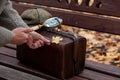 Large round magnifier on long handle in hand of naturalist