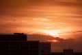 large round orange sunrise with cloudy sky over city for background Royalty Free Stock Photo