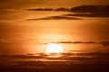 Large round orange sunrise or sunset with texture of cloudy sky for background Royalty Free Stock Photo