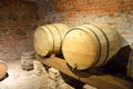 Large round wooden barrels for beer, wine in the old cellar of the Middle Ages made of brick Royalty Free Stock Photo