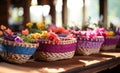a large row of colorful baskets of flowers sitting on a table Royalty Free Stock Photo