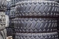 Large rubber tires for trucks lying on the street. Black tires close up with a large tread Royalty Free Stock Photo